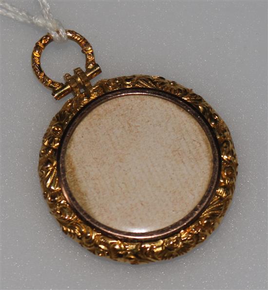 A late 19th/early 20th century yellow metal mounted pendant locket, 30mm.